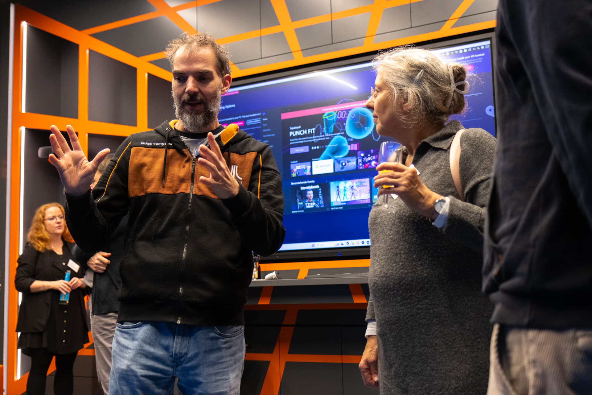 An IWM employee and an IWM alumna talking in the Mixed Reality Lab