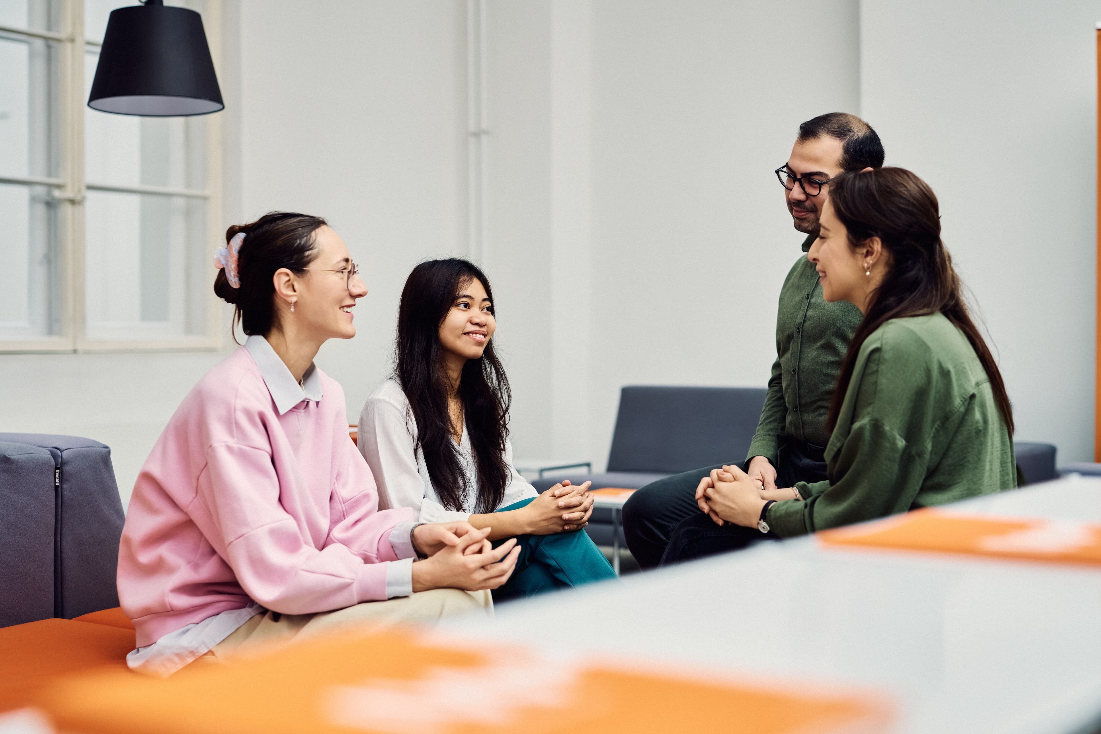 Four IWM employees sitting together and talking